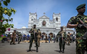 Sri Lankan military officers stand guard in front of the St Anthony's Church where an explosion took place in Kochchikade, Colombo, Sri Lanka, on Easter Sunday, April 21, 2019.