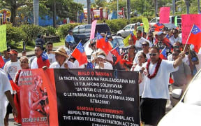 About 200 people marched through Samoa's capital, Apia, on Saturday, protesting against land laws.