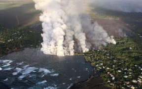 Lava flowing form Kilauea Volcano engulfing lenters Kapoho Bay on 4 June 2018.