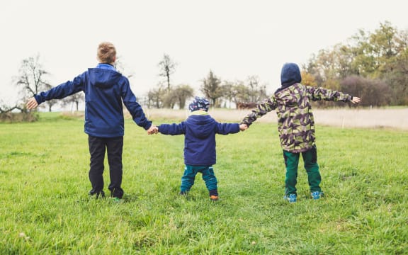 three kids holding hands
