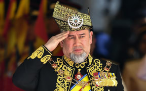This file photo taken on July 17, 2018 shows the 15th king of Malaysia, Sultan Muhammad V, saluting a royal guard of honour during the opening ceremony of the parliament in Kuala Lumpur. - Malaysia's King Sultan Muhammad V has abdicated, a statement from the National Palace said on January 6, 2019.