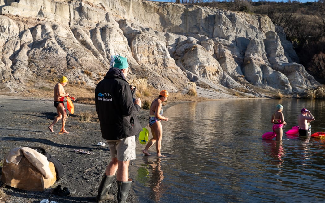 Athletes at the New Zealand ice swimming championships prepare to plunge into Otago's Blue Lake near St Bathans.