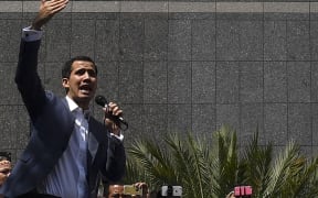The president of Venezuela's opposition-led National Assembly Juan Guaido speaks to the crowd during an extraordinary open meeting in front of the headquarters of the UN Development Programme in Caracas.