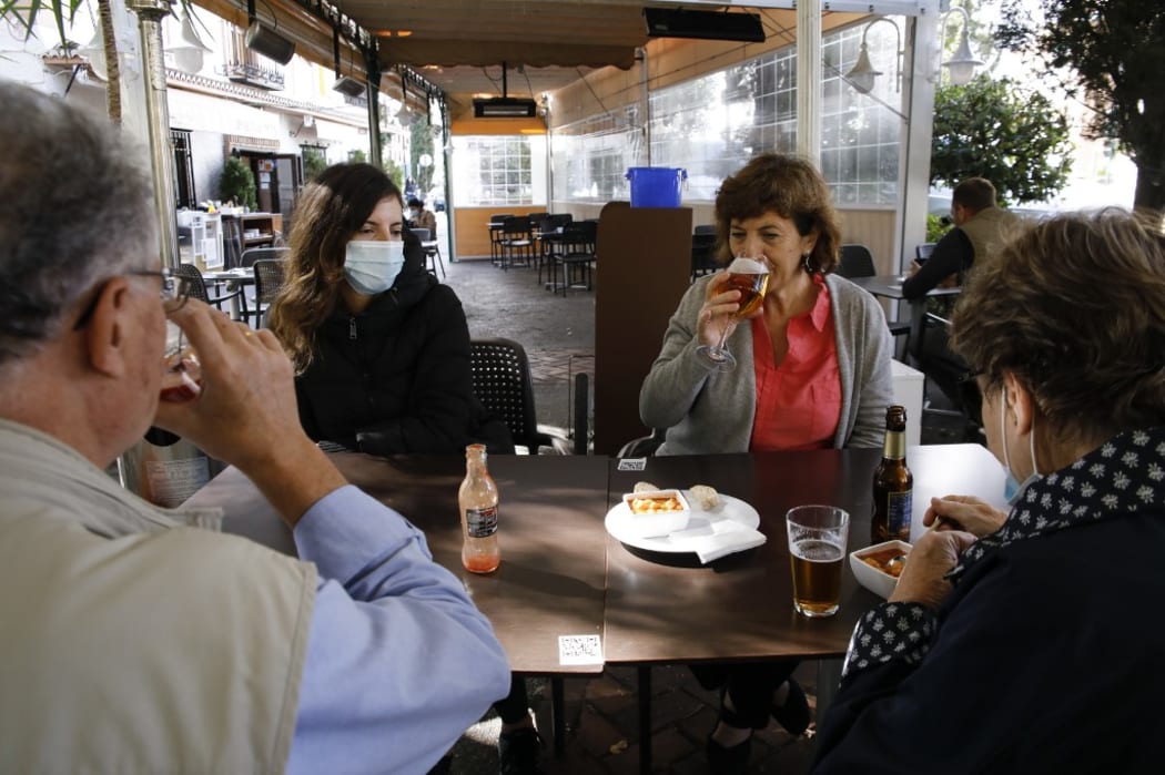 People in a restaurant in Granada on October 23, 2020. COVID-19 infections are increasing in Granada (Spain) and the Government of Andalusia decided to make wearing face masks mandatory