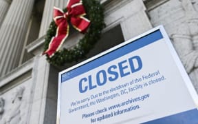 A sign is displayed at the National Archives building that is closed because of a US government shutdown in Washington, DC, on December 22, 2018. - AFP