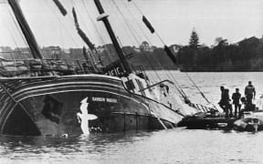 The Greenpeace flagship Rainbow Warrior lying in Auckland harbour after it was bombed in 1985.