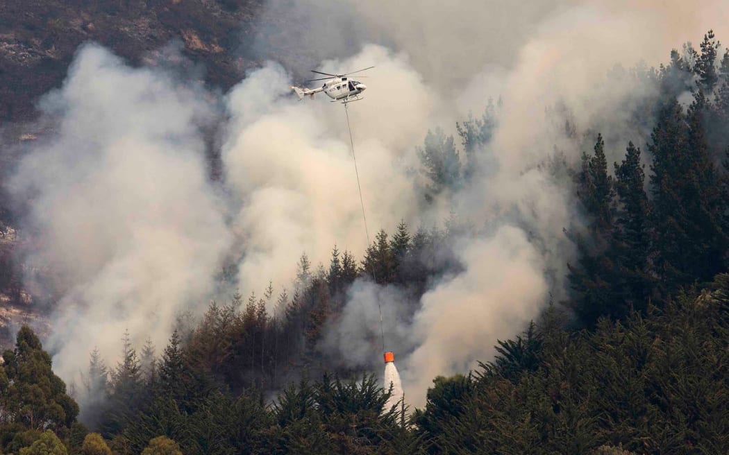 A helicopter takes part in the fire-fighting efforts on the Port hills.