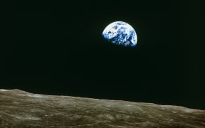 This photograph, taken during the Apollo 8 moon mission of 21-27 December 1968, shows the Earth rising - about 384,000 kilometers away.