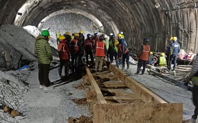 This handout photo taken on November 13, 2023, and released by the State Disaster Response Force (SDRF) shows rescue workers at the site after a tunnel collapsed in the Uttarkashi district of India's Uttarakhand state. More than a hundred rescuers in northern India struggled for a third day on November 14 to save workers trapped underground after the road tunnel they were building collapsed. (Photo by State Disaster Response Force (SDRF) / AFP) / RESTRICTED TO EDITORIAL USE - MANDATORY CREDIT "AFP PHOTO/State Disaster Response Force (SDRF)" - NO MARKETING NO ADVERTISING CAMPAIGNS - DISTRIBUTED AS A SERVICE TO CLIENTS