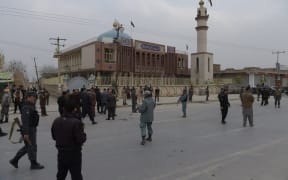 Afghan security personnel gather after a suicide blast at a Shiite mosque in Kabul.