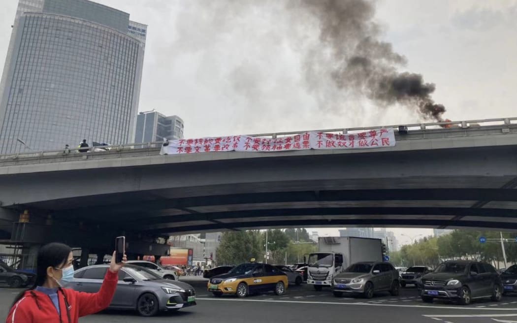 A rare protest occurred in Beijing ahead of the Chinese Communist Party congress. Text on the banner includes: 'Depose the Traitorous Dictator Xi Jinping’ and 'We Want Votes, Not Leaders; We Want Dignity, Not Lies; We are Citizens, not Slaves.'