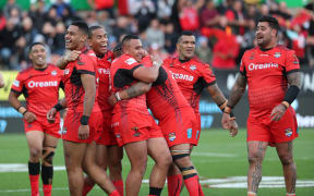 Tonga are all smiles after beating New Zealand to finish atop Group B.