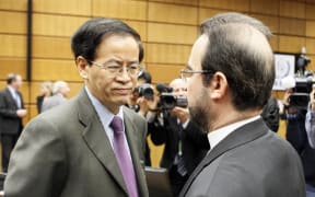 VIENNA, AUSTRIA - MARCH 3:  Iran's ambassador Reza Najafi (R) speaks to Chinas Ambassador to the IAEA Jingye Cheng (L) before the IAEA board of governors meeting at the International Center in Vienna, Austria, on March 3, 2014. Ali Haydar Yurtsever / Anadolu Agency