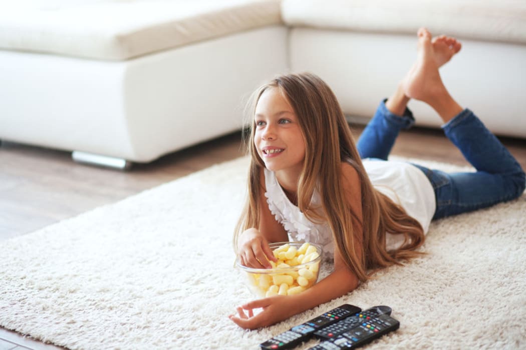 A child eating while watching TV