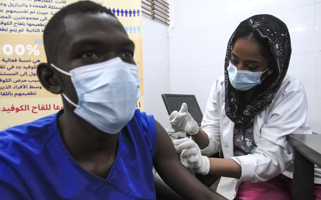 A medical worker receives a dose of the Oxford-AstraZeneca COVID-19 coronavirus vaccine at the Jabra Hospital for Emergency and Injuries in Sudan's capital Khartoum on March 9, 2021.