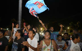 Workers and supporters of People's Alliance Party celebrate after securing the support of the Social Democratic Liberal Party (SODELPA) to form a new government in Suva on 20 December, 2022.