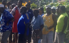 Voters line up outside a polling booth in Port Vila.