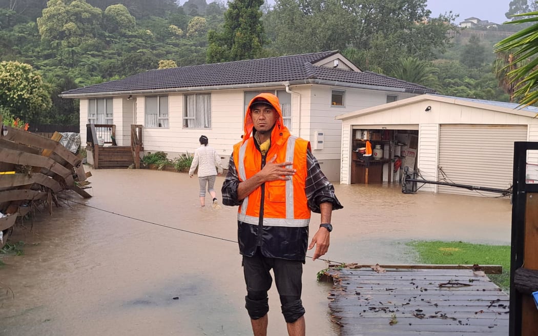 A resident on a flooded property in Auckland