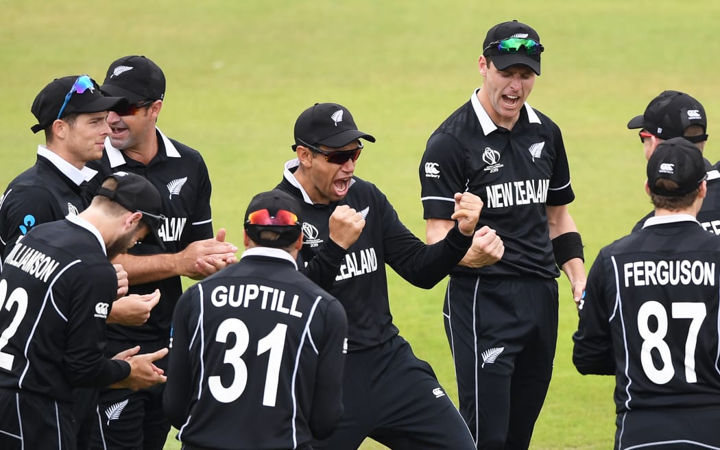 羅斯泰勒 (Ross Taylor) 和 Black Caps 球員在 2019 年板球世界杯半決賽中接受檢閱後慶祝印度選手維拉特科利 (Virat Kohli) 的三柱門。