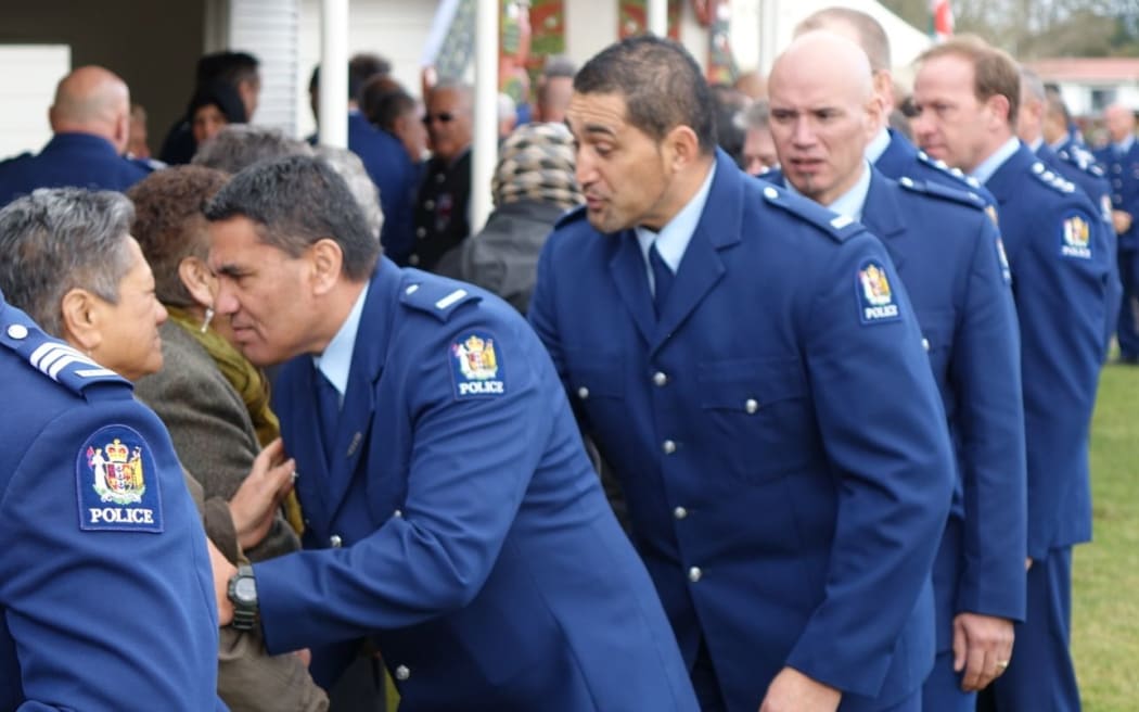 Officers greet people  at Te Rewarewa Marae.