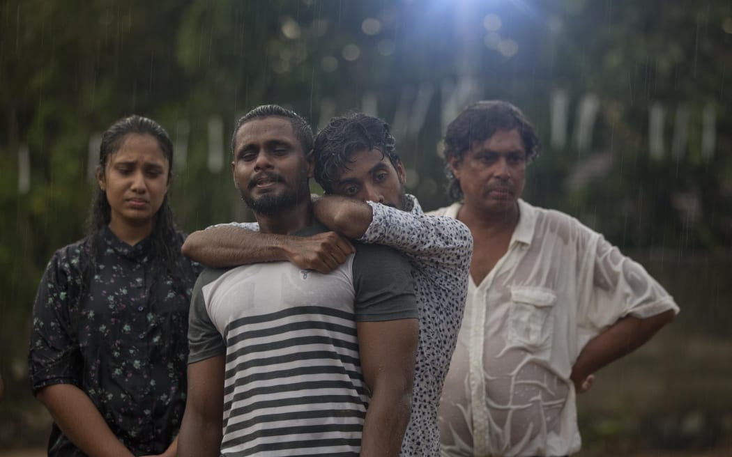 Mourners grieve at the burial of three members of the same family victims of Easter Sunday bomb blast at St. Sebastian Church in Negombo, Sri Lanka, Monday, April 22, 2019.