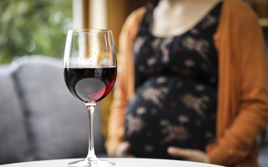 Generic pregnant woman drinking alcohol.