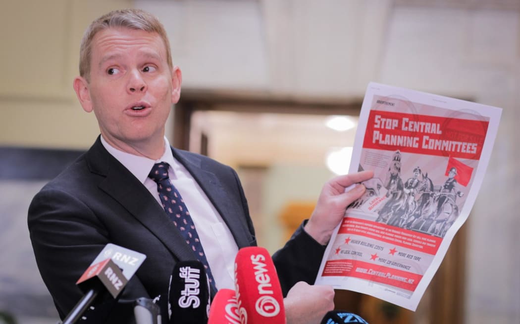 Labour Leader Chris Hipkins holds up a series of attacks ads which mention him or other Labour MPs. He says they have been shared by National and/or its MPs.
