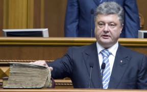 Ukraine's President Petro Poroshenko swearing on the Bible during a ceremony in the parliament in Kiev.