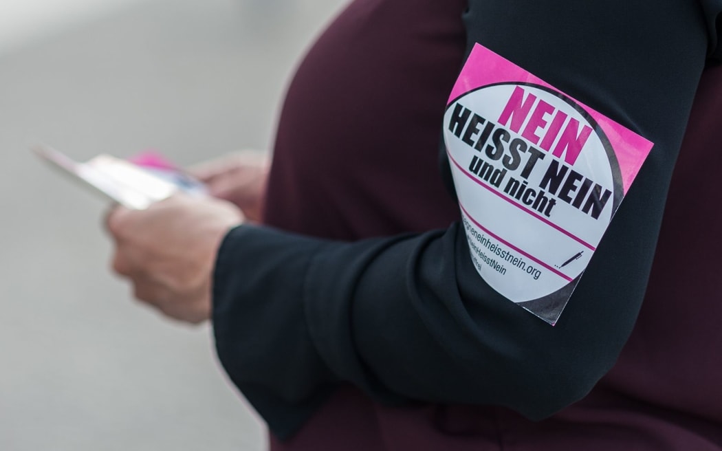 A woman with a sticker reading 'No means no' protests against certain contents of the reform of the law governing sexual offences in Berlin.