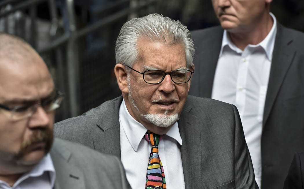 Rolf Harris (C) arrives at Southwark Crown Court in central London on 4 July 2014.
