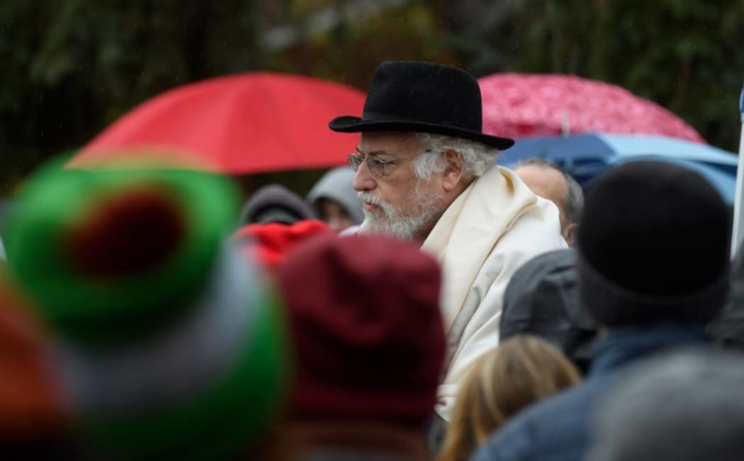 A rabbi conducts a prayer vigil in front of the Tree of Life Synagogue in Pittsburgh, Pennsylvania, where 11 people were shot dead in October. Jewish Americans suffer the most hate crimes of any religion in the US.
