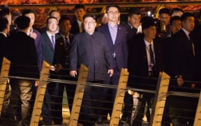 North Korean leader Kim Jong-un (centre) touring Singapore's Marina Bay Area, on a night-time stroll around some of Singapore's sights.