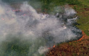 Aerial view of a large forest fire in Ramal do Cinturao Verde, in the Janauaca District, Careiro Castanho, 113 km from Manaus, Amazon.