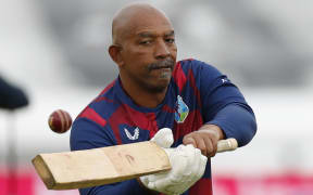 West Indies coach Phil Simmons gives his players catching practice during warm up on the second day of the first Test cricket match against England at the Ageas Bowl in Southampton on July 9, 2020.