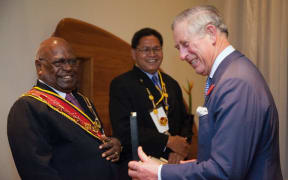 Britain's Prince Charles (R) receives the Grand Companion of the Order of Logohu medal from Papua New Guinea's Governor General, Sir Michael Ogio (L) after arriving in Port Moresby on November 3, 2012