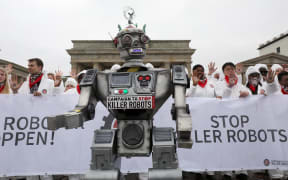 Protesters make their views known on killer robots in front of Berlin's Brandenburg gate, March 21 2019.