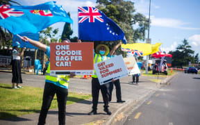 Fiji, Cook Islands, Niue and Tongan flags waved to passersby