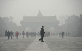 A man walks through smog at a the Temple of Heaven park in Beijing last month.