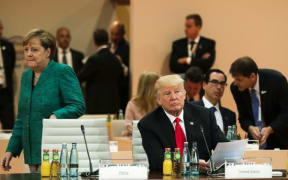 American president Donald Trump and German chancellor Angela Merkel attend G20 talks.