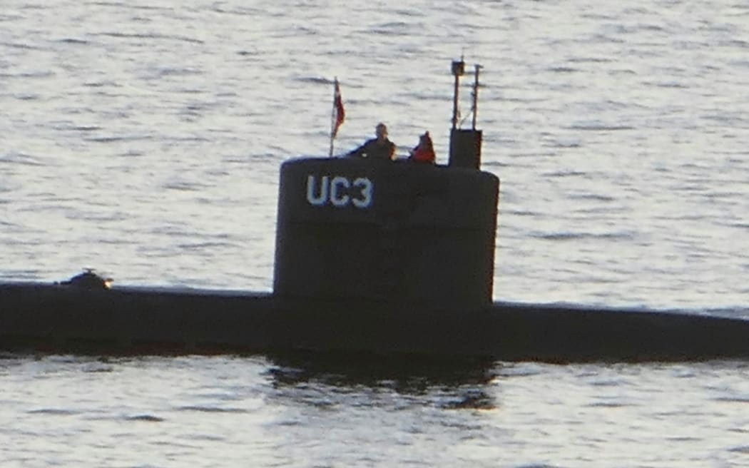 An image from Danish media that allegedly Swedish journalist Kim Wall standing next to a man in the tower of the private submarine UC3 Nautilus.