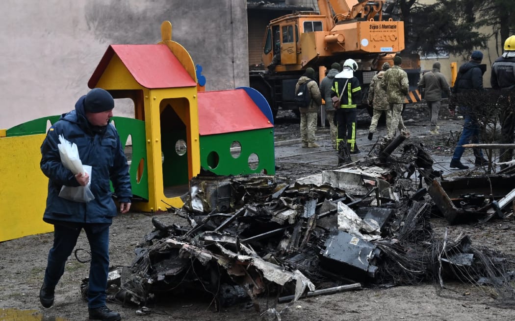 Firefighters work near the site of a helicopter crash near a kindergarten in Ukraine.