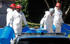 Hazmat workers prepare to decontaminate the apartment where a second nurse who tested positive for Ebola lives.