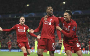 Liverpool's Georginio Wijnaldum, center, celebrates scoring his side's third goal during the Champions League semi final between Liverpool and Barcelona at Anfield.