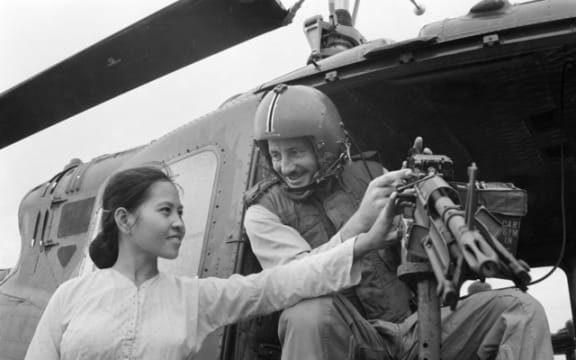 Vietnamese woman examines an M60 machine gun on a No. 9 Squadron UH-1