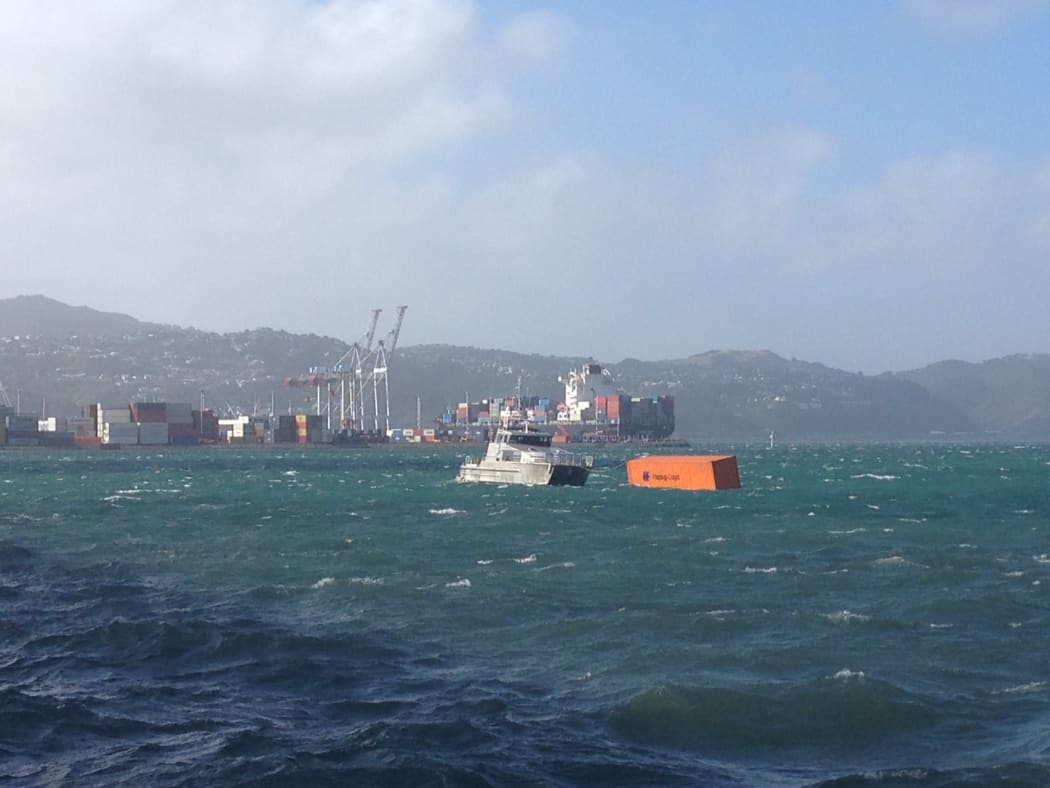 A photo shows containers floating in Wellington Harbour.