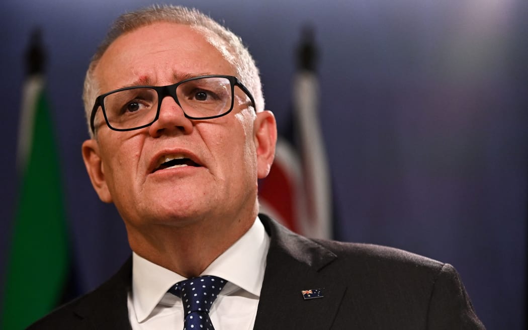 Australia's former prime minister Scott Morrison speaks to media during a press conference in Sydney on August 17, 2022. - Australia's Prime Minister Anthony Albanese on August 16 said that his predecessor Scott Morrison secretly seized control of five ministerial posts, labelling it an "unprecedented trashing of our democracy". (Photo by Steven Saphore / AFP)