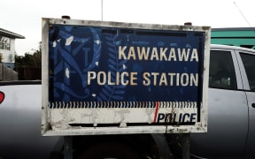 A tatty sign covered in dirt and lichen which says "Kawakawa Police Station"