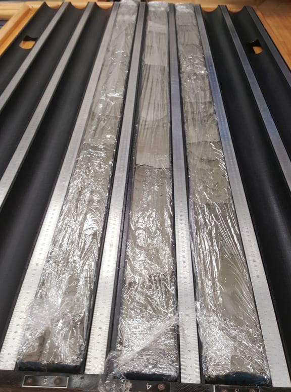 Sediment cores taken from New Zealand's largest earthquake fault. The cores are made up from layers of sand, silt and volcanic ash. The plastic wrap keeps the cores moist.