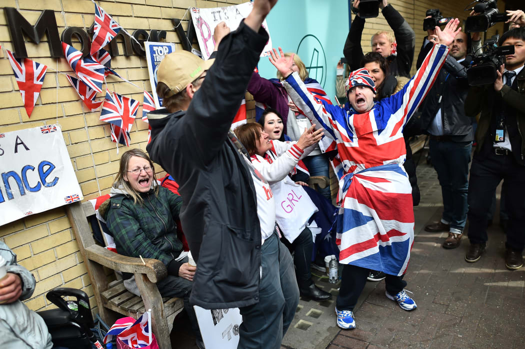 Royal fans are surrounded by media as they celebrate following the announcement of the birth of Catherine, Duchess of Cambridge and Prince William's second child, a daughter, outside the Lindo wing at St Mary's hospital in central London.