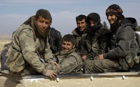 Fighters from the Syrian Democratic Forces are transported to the front line of the town of al-Shadadi in the northeastern Syrian province of Hasakeh, on February 19, 2016.